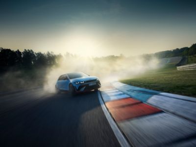 The all-electric Hyundai IONIQ 5 N drifting through a racetrack curve.