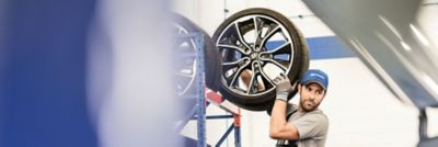 Hyundai technician holding a spare wheel