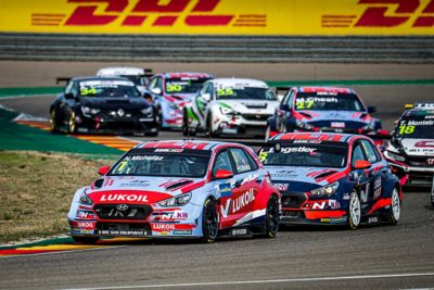 The Hyundai Motorsport customer racing i30 N VELOSTER leading the pack on racetrack.