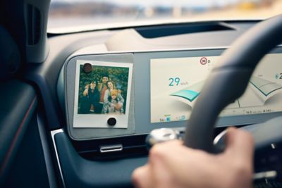 A family photo attached to the digital cluster of a Hyundai IONIQ 5 midsize electric CUV.