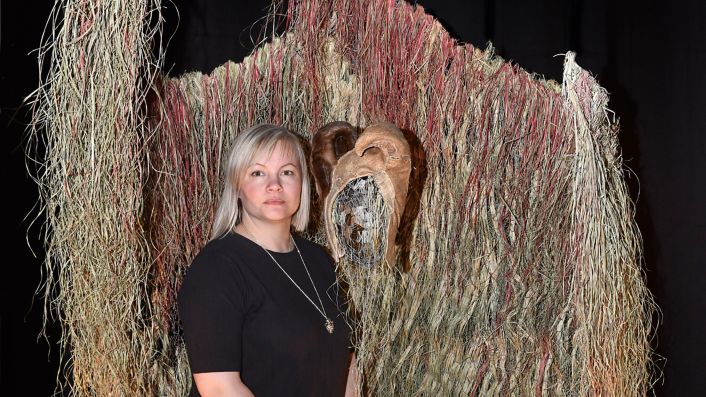 Máret Ánne Sara (1983-) with her artwork at the exhibition “Environmental Injustice – Indigenous Peoples’ Alternatives” (2021-2022) at Musée d’ethnographie de Genève (MEG), Switzerland 2021 MEG Inv. ETHPH  90345 © Photo Johnathan Watts, MEG