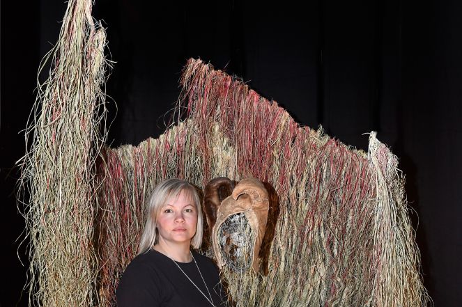 Máret Ánne Sara (1983-) with her artwork at the exhibition “Environmental Injustice – Indigenous Peoples’ Alternatives” (2021-2022) at Musée d’ethnographie de Genève (MEG), Switzerland 2021 MEG Inv. ETHPH  90345 © Photo Johnathan Watts, MEG