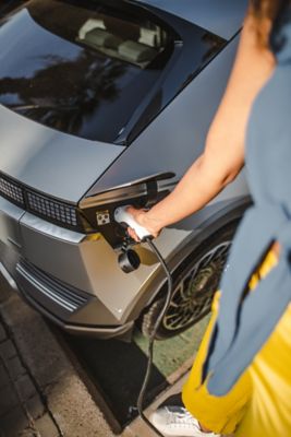 Detailansicht des Hyundai IONIQ 5 Ladeanschlusses: Ein Ladekabel wird eingesteckt. 