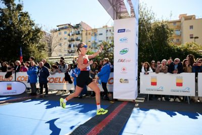 Hyundai mechanic inspecting the underside of a vehicle near the tire.