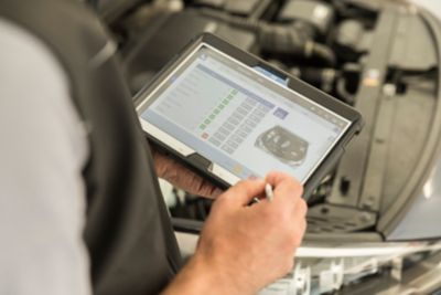 Hyundai technician looking at a screen to carry out electric vehicle health check