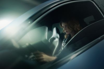 A woman sitting in the driver's seat of the Hyundai IONIQ 5 N.	