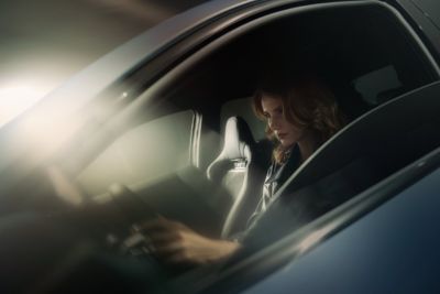  A woman sitting in the driver's seat of the all-electric Hyundai IONIQ 5 N.