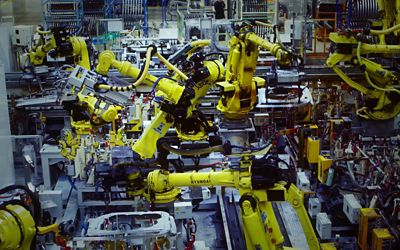 Robotic arms at work in a Hyundai manufacturing facility.