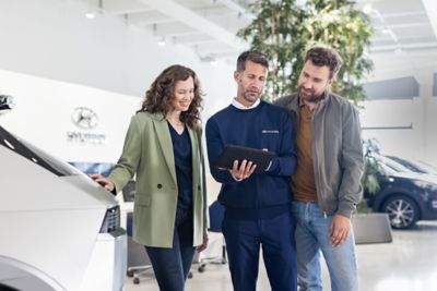 Hyundai technician talking to customers about their car