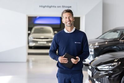 Hyundai fleet team member holding a tablet in hand. 
