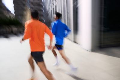 Hyundai mechanic inspecting the underside of a vehicle near the tire.