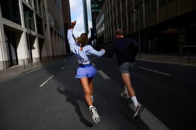 Hyundai mechanic inspecting the underside of a vehicle near the tire.
