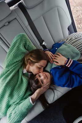 A mother and her child in the back of a Hyundai electric vehicle.