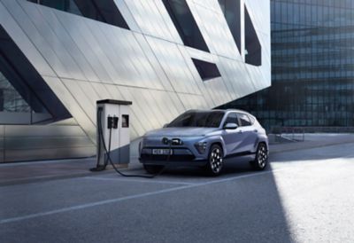 The charging socket of the Hyundai KONA Electric with a plugged in charging cable.