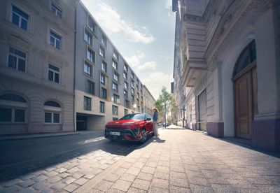 The front and side view of the all-new KONA N Line in red.