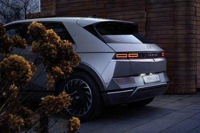 The IONIQ 5 parked in a driveway pictured from the back.