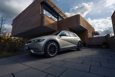 The Hyundai IONIQ 5 electric vehicle pictured from the front in a beautiful house.