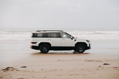 The Hyundai Santa Fe SUV parked between high walls in the sunshine.