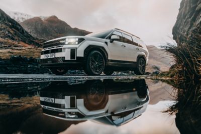 The Hyundai Santa Fe parked with the mountains in the background.