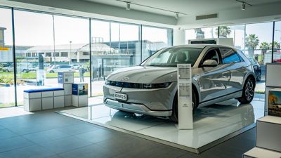 Hyundai IONIQ 5 grigia chiara dentro lo showroom