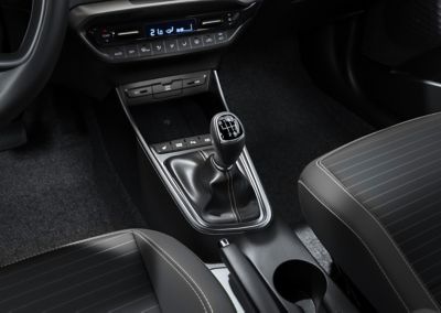 A manual transmission gear lever inside a Hyundai i20.