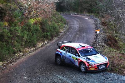 Hyundai Motorsport customer racing rally car i20 R5 in action on a gravel road.