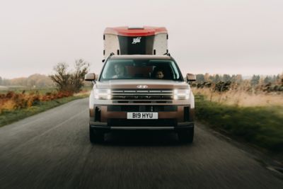 Hyundai SANTA FE towing a horsebox on the road.