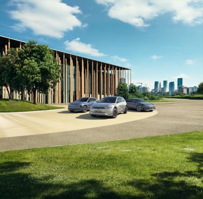 KONA electric, IONIQ 5 and IONIQ 6 parked in front of a building.