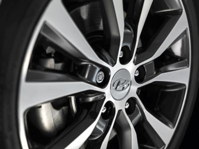 Hyundai alloy wheel with Hyundai emblem.