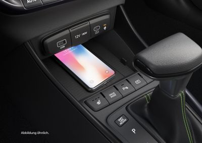 Die kabellose Ladeablage des Hyundai i20 mit darauf liegendem Smartphone.