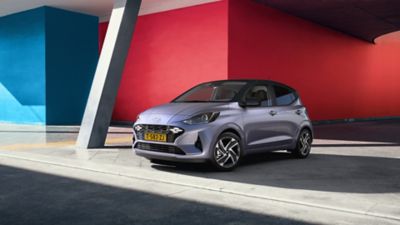 Hyundai i10 met een lopende vrouw