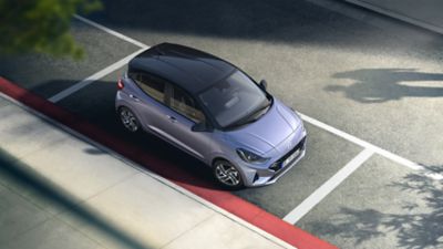 Hyundai i10 parked on the street seen from above.