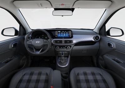 Interior view of the Hyundai i10 cockpit, front seats and steering wheel.