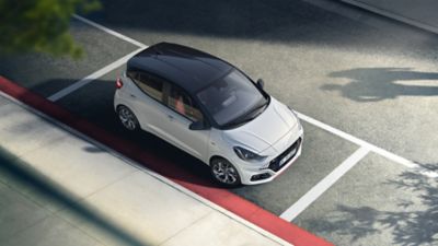 The Hyundai i10 N Line parked on a city street shown from above.