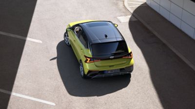 Two Hyundai i20s in an alley, parked at a 90 degree angle 