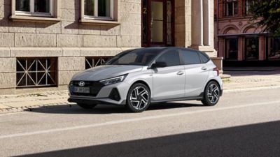 The new Hyundai i20 N Line parked in front of a city building.