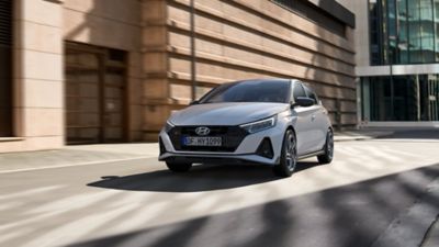 The all-new Hyundai i20 N Line in front of a building with large windows