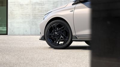 Close-up view of one of the i20 N Line's newly designed 17” alloy wheels in black.