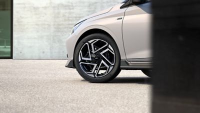 Close-up view of one of the i20 N Line's newly designed 17” alloy wheels in black.