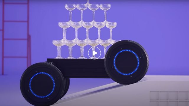 MobED (Mobile Eccentric Droid) navigating an obstacle while transporting stacked champagne glasses