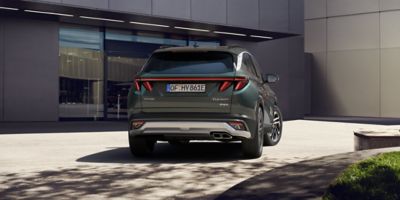 The Hyundai TUCSON Plug-in Hybrid parked in front of a building. 