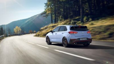 A young woman smiling as she gets ready to drive her new i30 N performance hatchback.