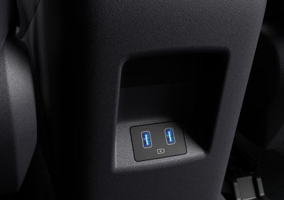 The centre console of the Hyundai Tucson compact SUV showing the front and rear USB ports.
