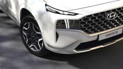 The Hyundai Santa Fe Plug-in Hybrid 7 seat SUV showing its new full LED headlamps and bumper.