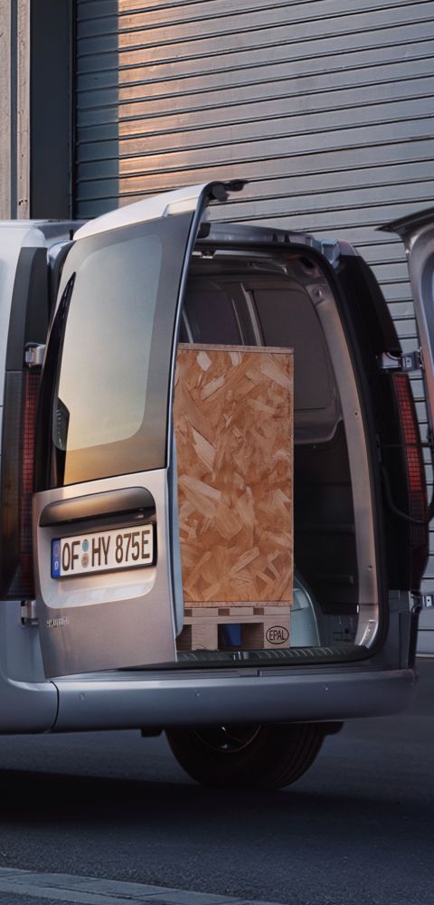 Driekwart achteraanzicht Hyundai STARIA Cargo met geopende schuifdeur en geopende dubbele achterdeuren.