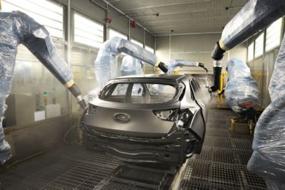 A Hyundai car getting painted at a Hyundai production site.