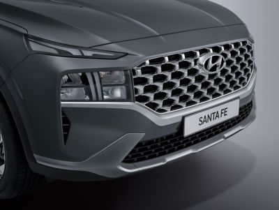 The Hyundai Santa Fe Plug-in Hybrid 7 seat SUV driving on a forest road.