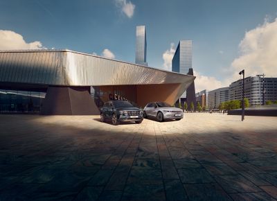 The Hyundai TUCSON and IONIQ 5 parked in front of a modern building