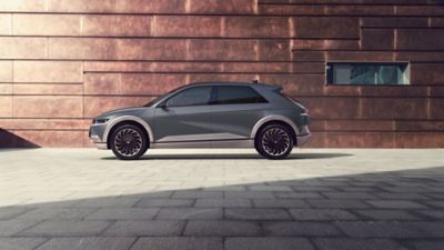 Hyundai IONIQ 5 parked in front of a brick wall