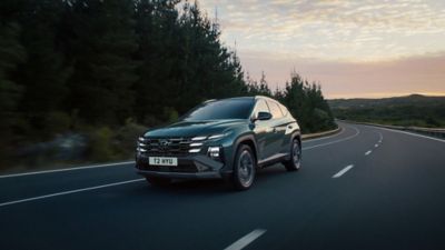 The Hyundai TUCSON driving along the road.